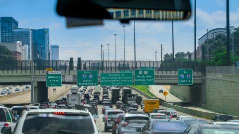 An image showing a wide highway in Atlanta packed with cars from a drivers seat.