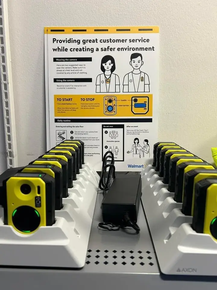 a picture of a rack of walmart body cameras to be used by shop floor staff, with the title “providing great customer service while creating a safer environment”