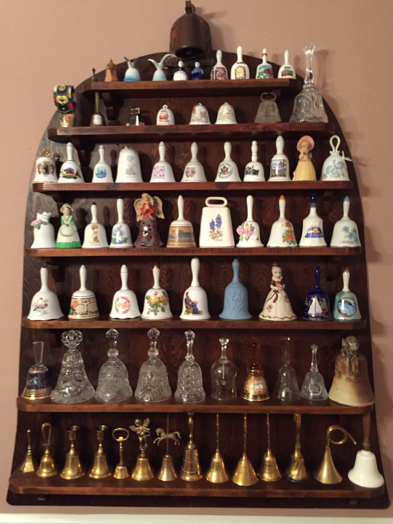 A large cabinet of decorative, collectible hand bells.