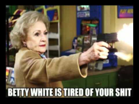 Betty White, holding a gun and shooting at an off-screen target.