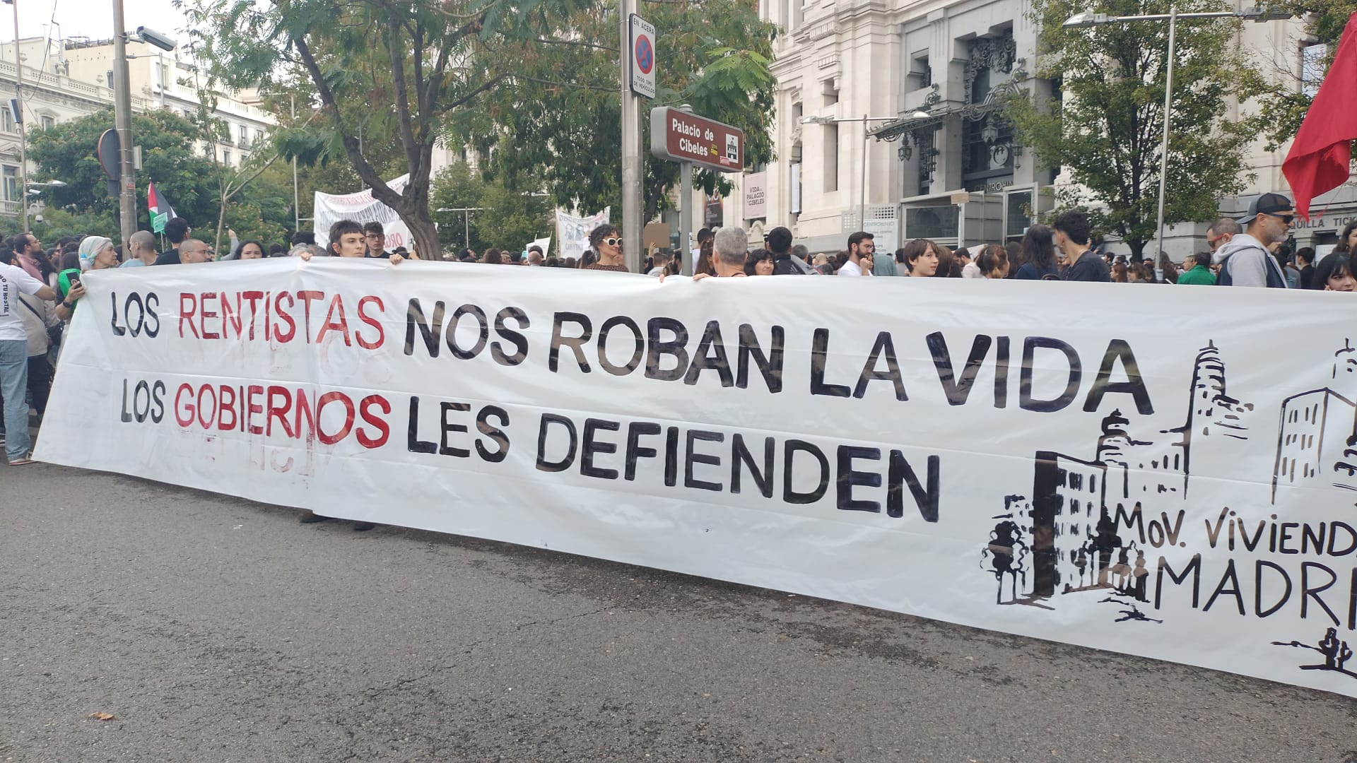 Banner reading "The renters robs us of our lives, the government defends them"