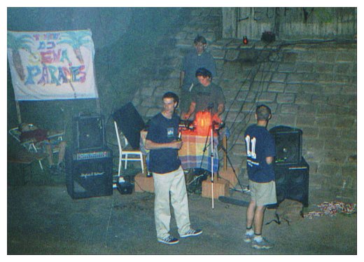 People at a party, a DJ spinning vinyl records