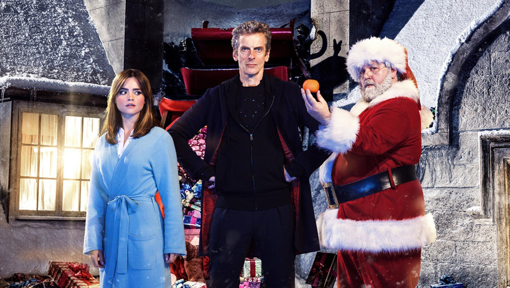 The Twelfth Doctor, Clara Oswald, and Santa Claus standing in front of Santa's sleigh.