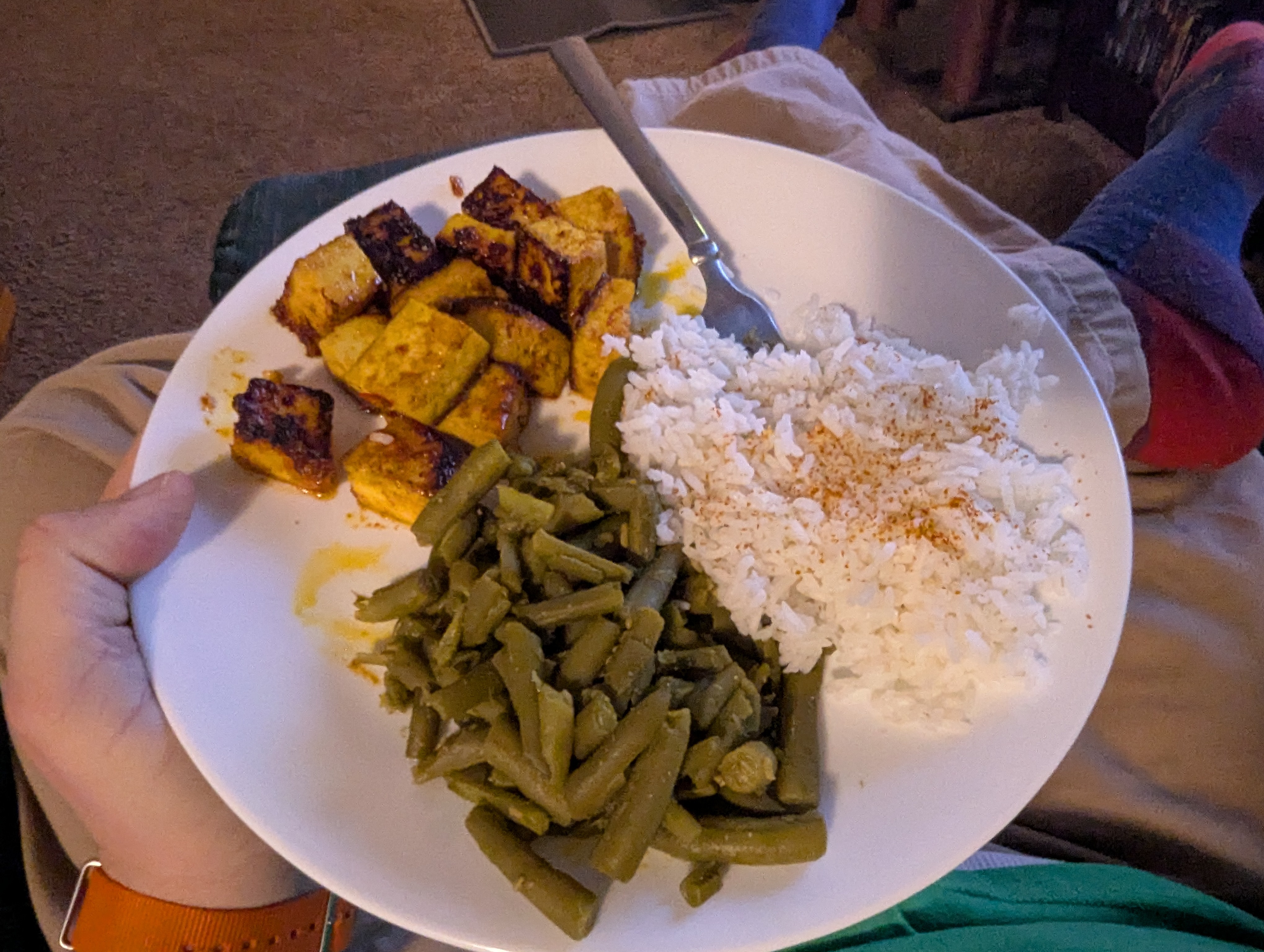 yellow tofu, green beans, and white rice on a white plate