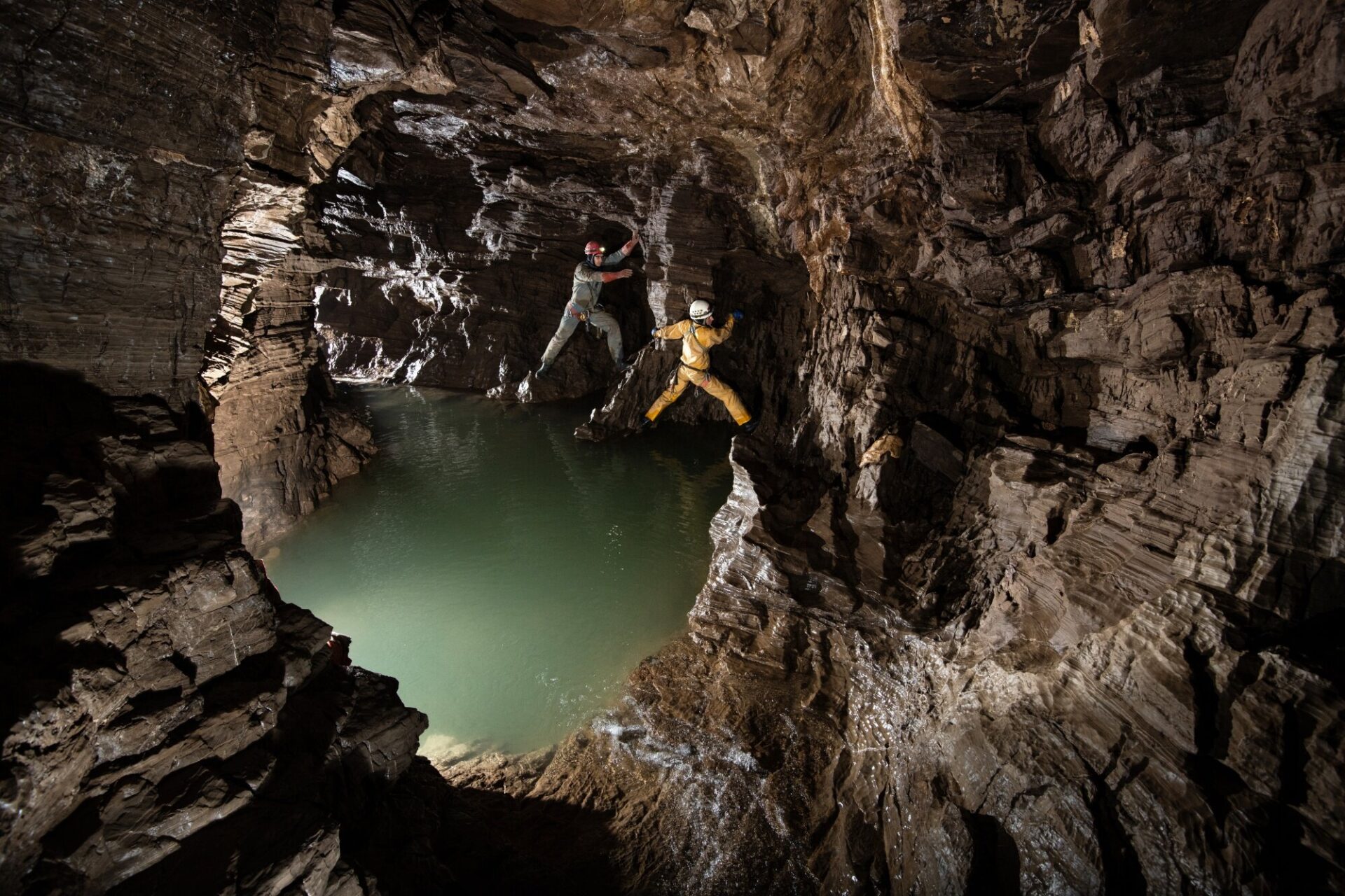 Natasha Sizikova and Roman Zverev of the Perovo Speleo Caving Team on a traverse around a deep pool of water in one side passage off the main route through the lowest levels of Veryovnika. During the flood pulse that raged into these chambers during the expedition this gallery completely filled up with water, and was totally submerged.